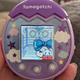 Photo of the purple Tamagotchi Pix in a hand